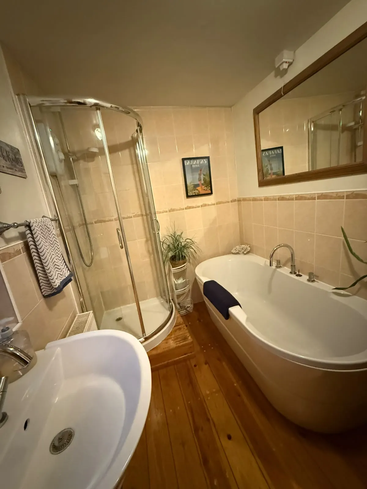 Bathroom with a freestanding bath and a separate glass shower cubicle