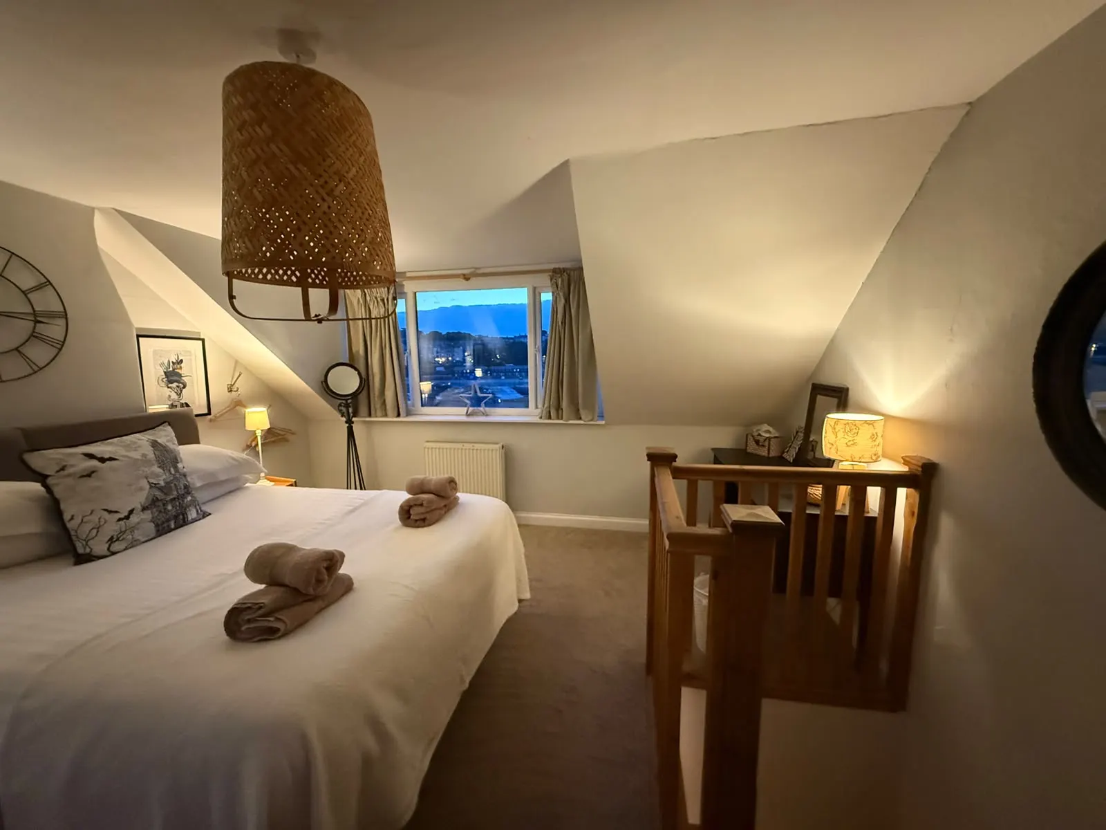 Top-floor bedroom showing the stair opening and window over Whitby