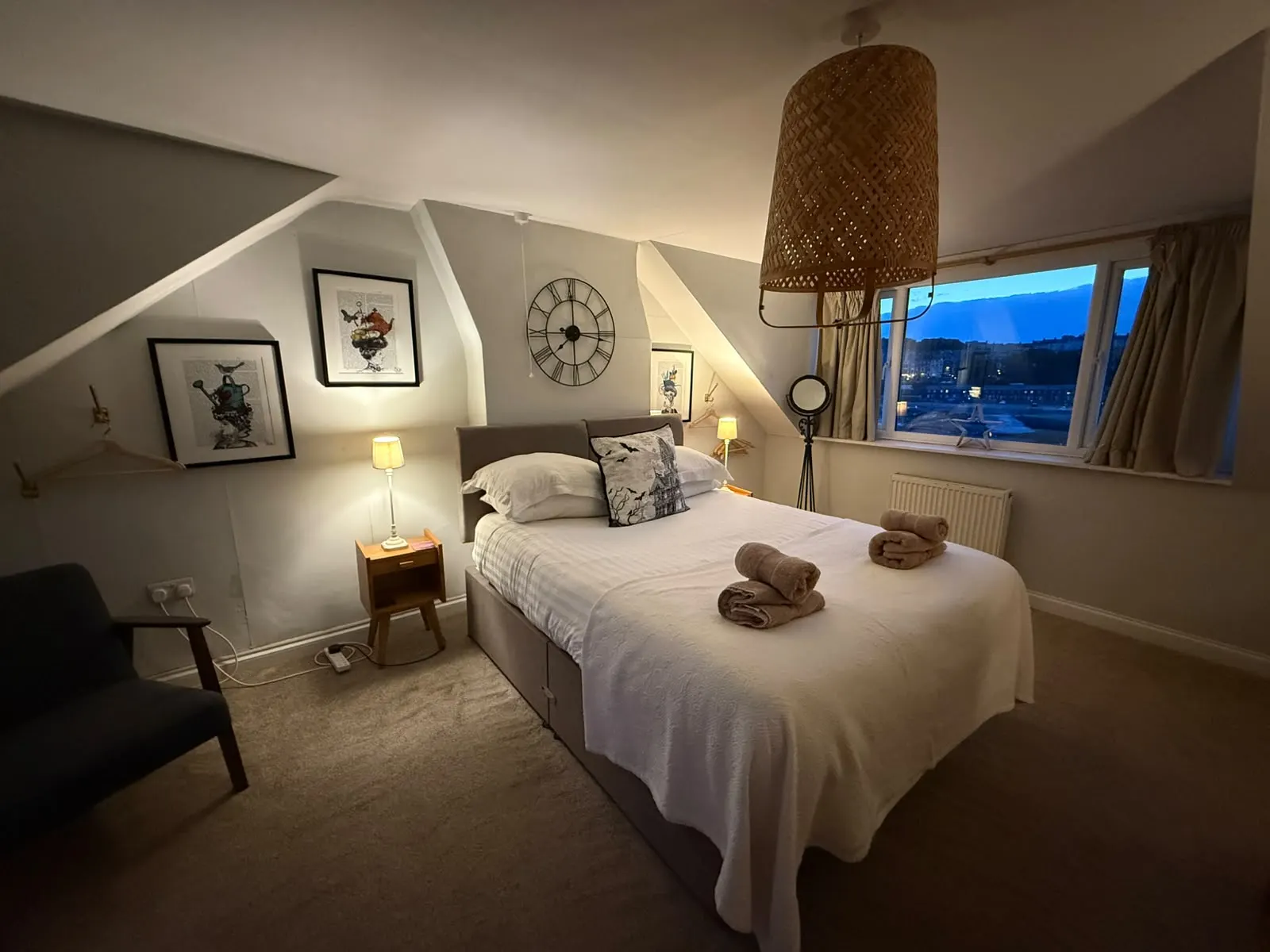 Super-king bedroom under the eaves with a marina view at dusk