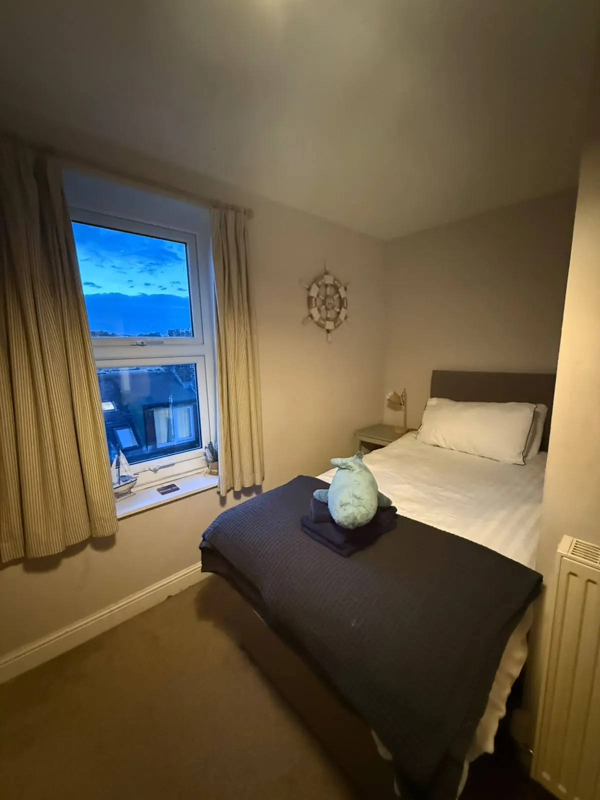 Twin bedroom with a window looking out over Whitby rooftops