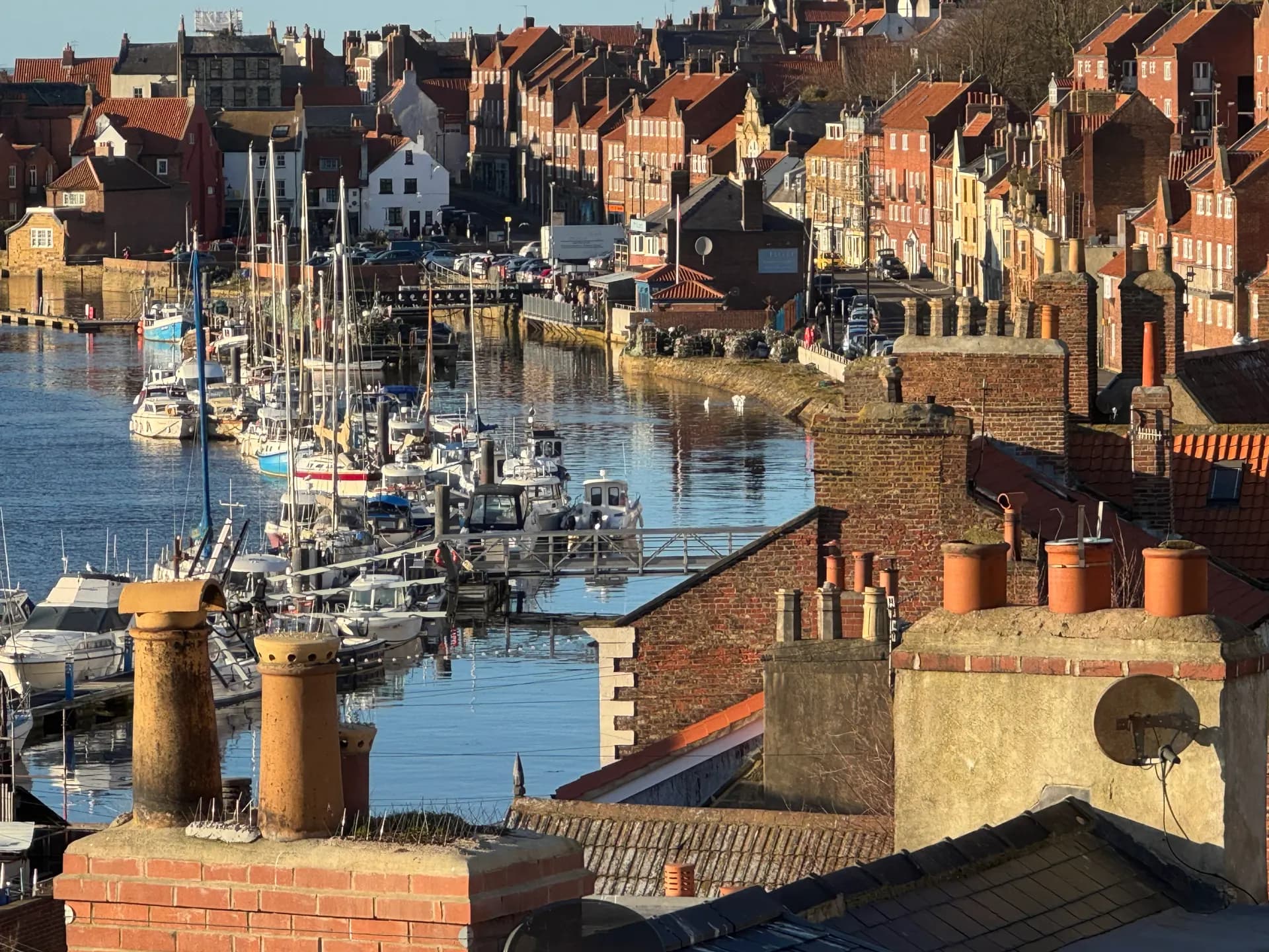 Whitby marina and the River Esk seen over cottage rooftops from Pipit House